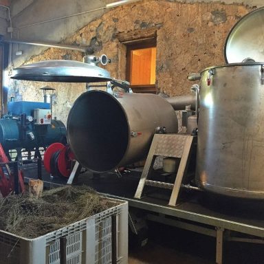 Equipo industrial con tanques y tuberías en un ambiente rústico.